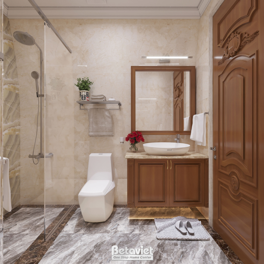 Phòng tắm có vòi sen mưa sau kính, tủ lavabo gỗ, gương khung gỗ lớn, tường đá be, thảm chân trải trước bồn cầu.