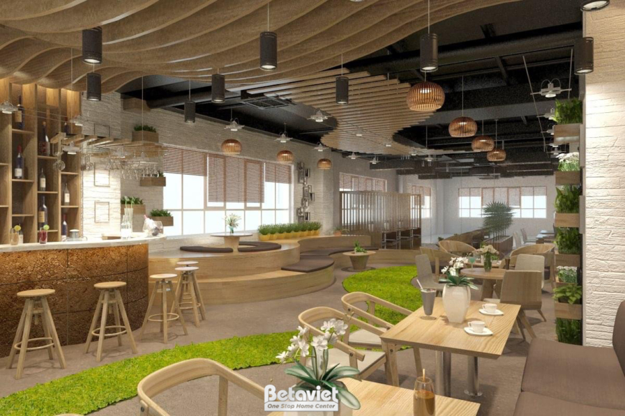 Toàn cảnh không gian quán cafe với bố cục linh hoạt, nhiều khu vực ngồi khác nhau. Nổi bật là thảm cỏ nhân tạo uốn lượn, t…