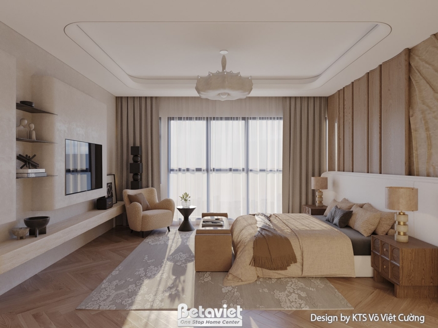 Phòng ngủ với giường đôi, đầu giường ốp gỗ và đá vân. Kệ tivi treo tường và ghế thư giãn đặt cạnh cửa sổ. Rèm cửa 2 lớp đi…