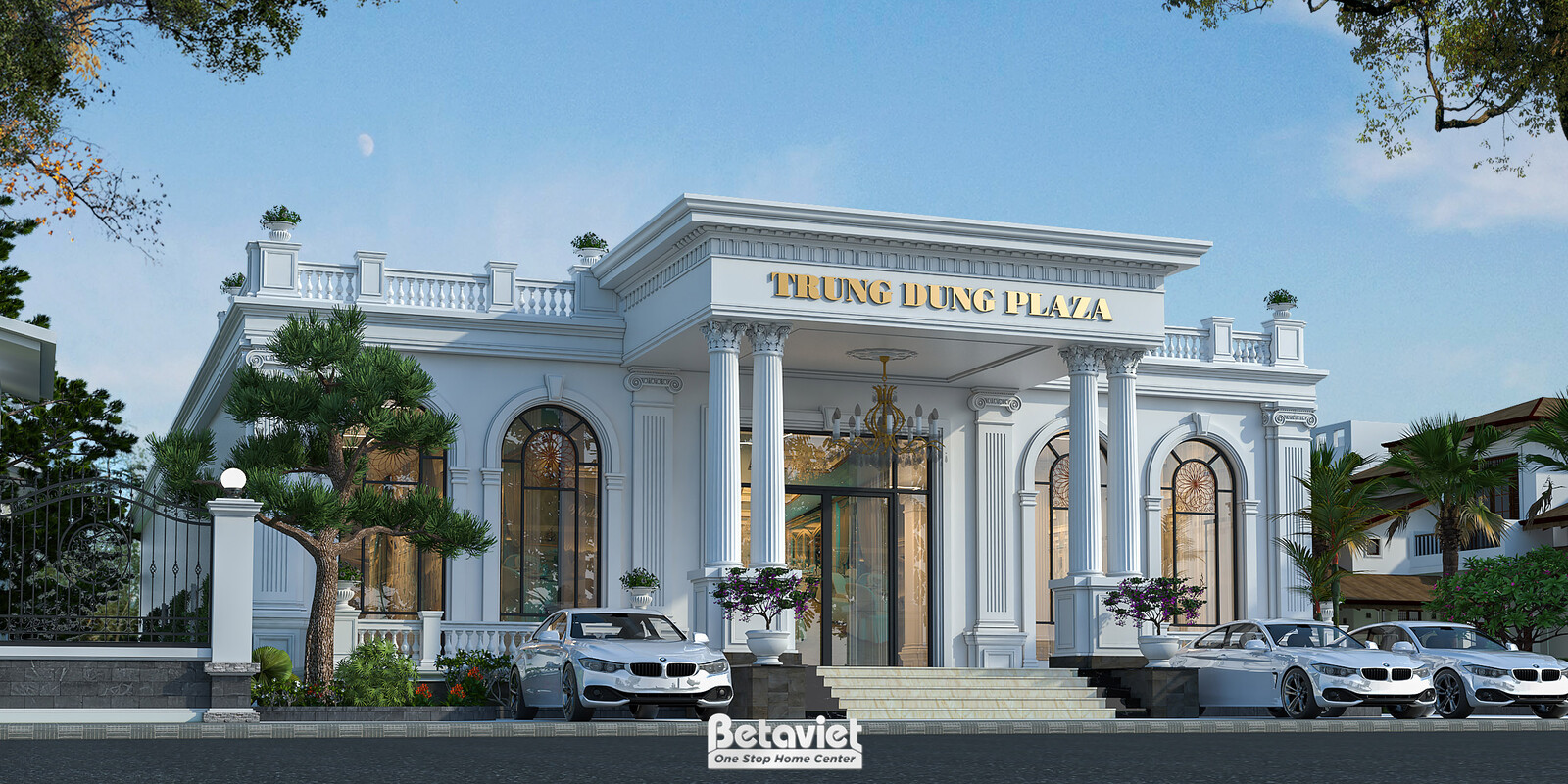 Góc chụp xiên từ xa bao quát toàn bộ công trình cùng sân vườn phía trước, lan can đá chạm khắc trên mái, hàng cây thông tạ…