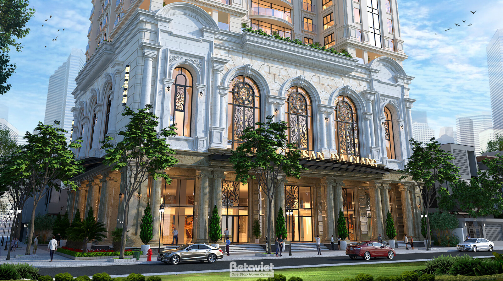 Cận cảnh tầng đế khách sạn, hệ cột thức cổ điển đầu cột chạm khắc kiểu Corinth, tường ốp đá tông trắng kem, cửa vòm kính l…