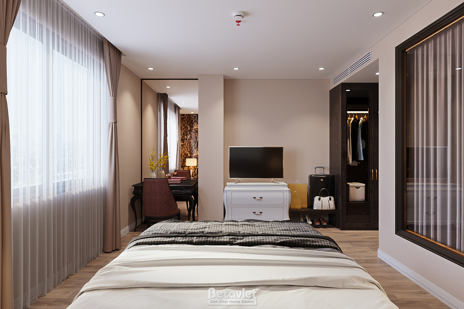 Phòng ngủ khách sạn với bàn làm việc, tủ minibar, rèm voan buông mềm, giường nệm nâu đồng bộ. Tường be trơn, ánh sáng tự n…