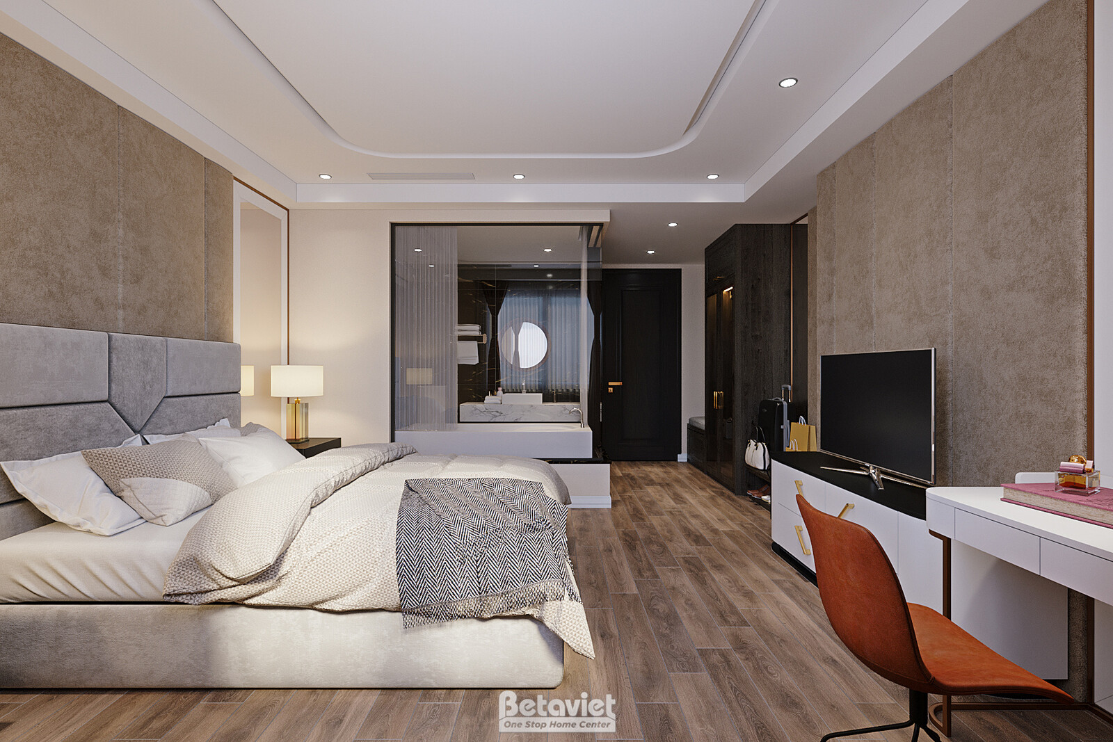 Phòng ngủ khách sạn đầu giường bọc nệm xám, bàn console gương hình thoi, ghế thư giãn màu cam làm điểm nhấn. Tường be, ánh…
