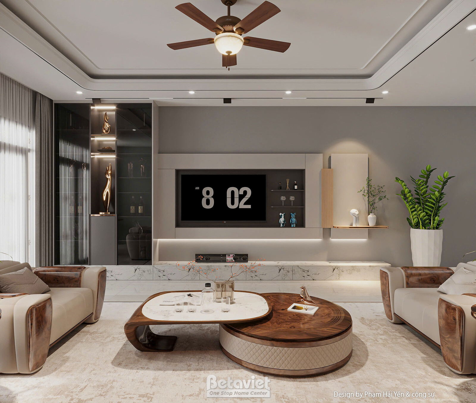 Góc rộng phòng khách với bộ ghế sofa da kem tay vịn gỗ nâu, bàn trà đôi đá trắng - gỗ đan xen, cây xanh trang trí góc phòn…