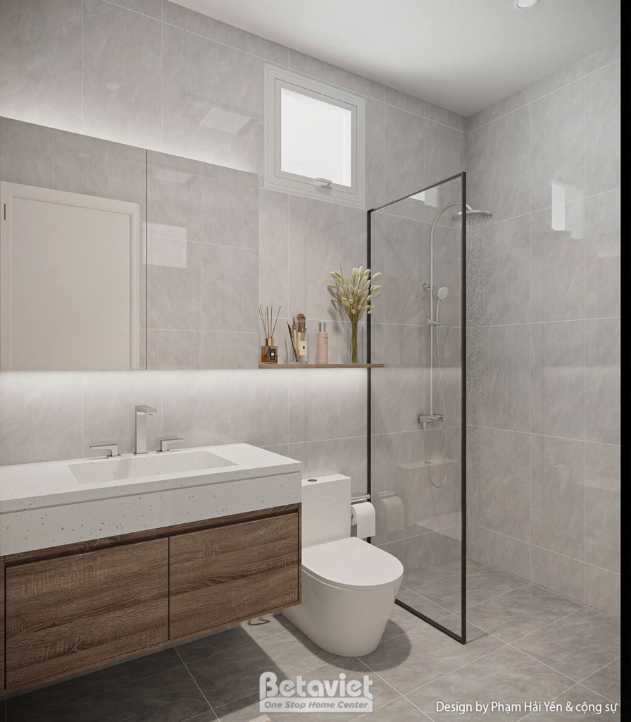 Phòng vệ sinh với lavabo đá nhân tạo đặt trên tủ gỗ treo tường, vách kính cường lực phân khu khô - ướt rõ ràng. Toilet đặt…