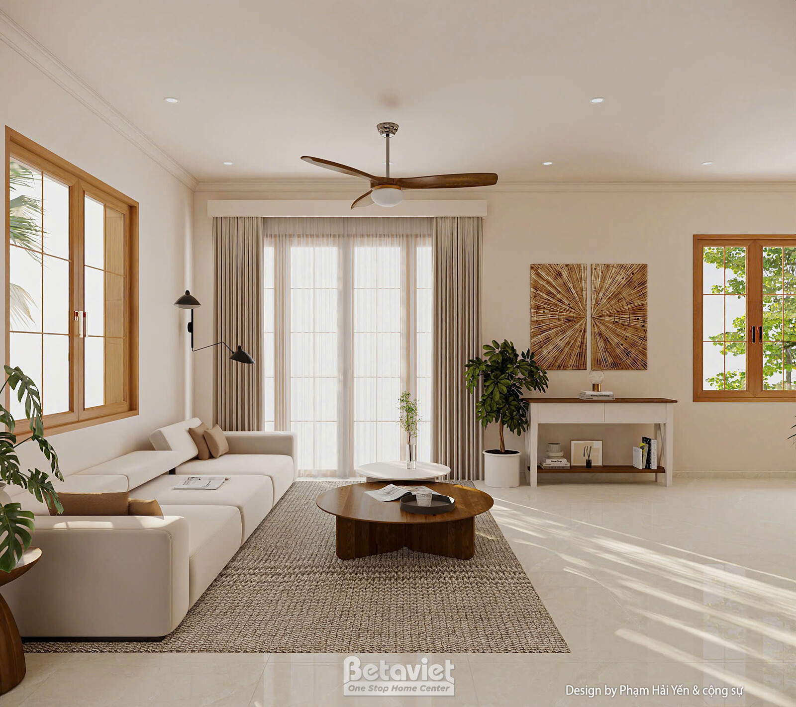 Góc sofa chữ L bên cửa kính rèm dài, kệ console gỗ trắng bày sách trang trí, tranh nghệ thuật hình mặt trời chạm gỗ, quạt…