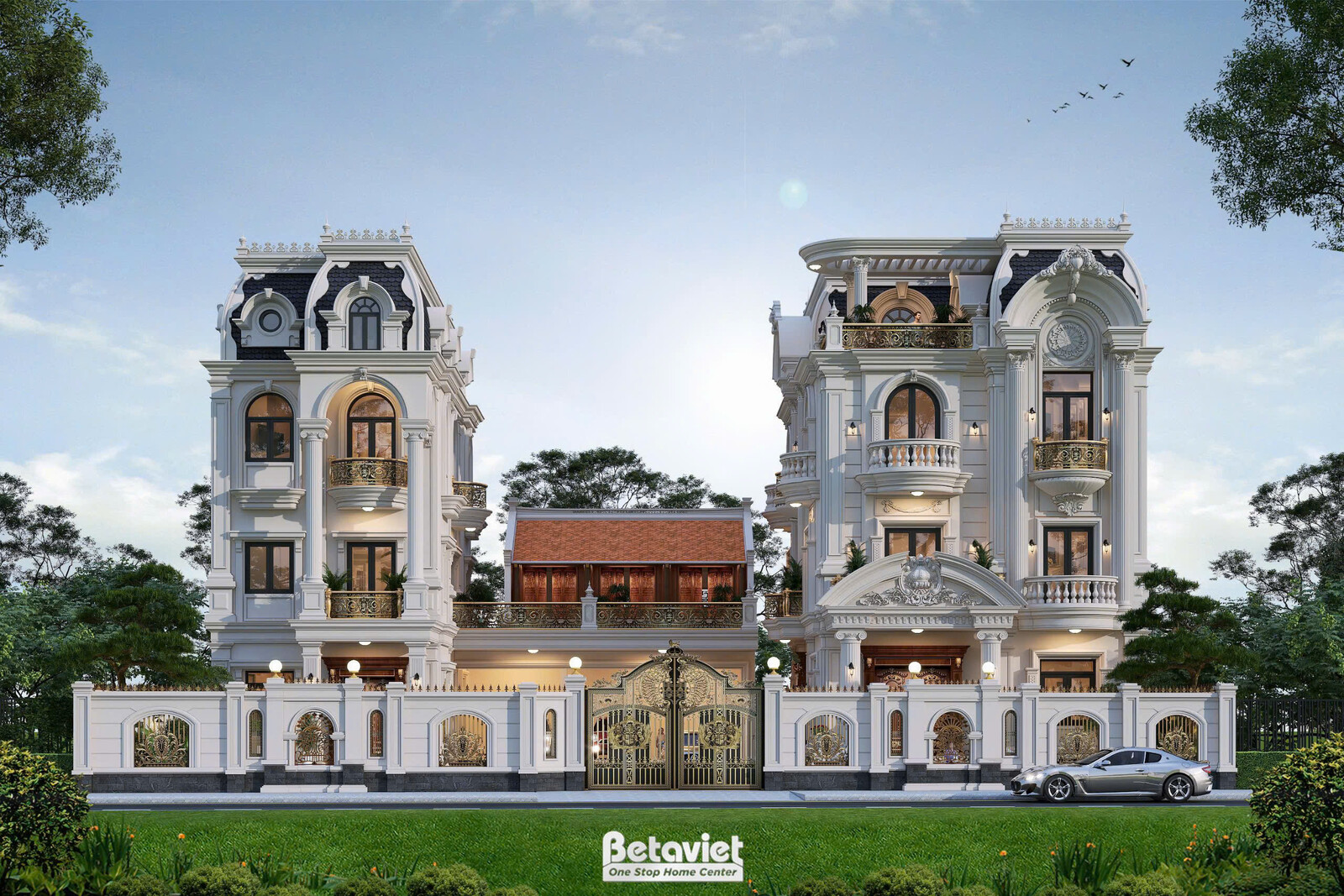 Góc nhìn chéo thể hiện hai khối nhà Mansard đối xứng hai bên khối thấp mái ngói đỏ ở giữa, phía trước là cổng sắt nghệ thu…
