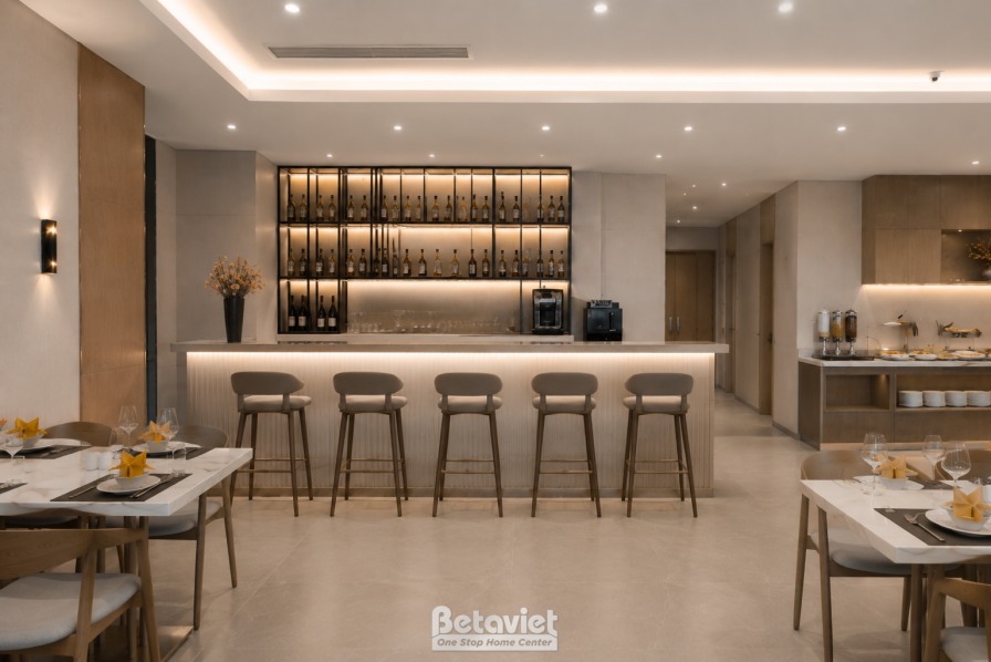 Quầy bar rượu vang với kệ trưng bày chai rượu chiếu đèn hắt ấm, mặt quầy đá trắng kết hợp ghế bar cao chân gỗ, khu bàn ăn…