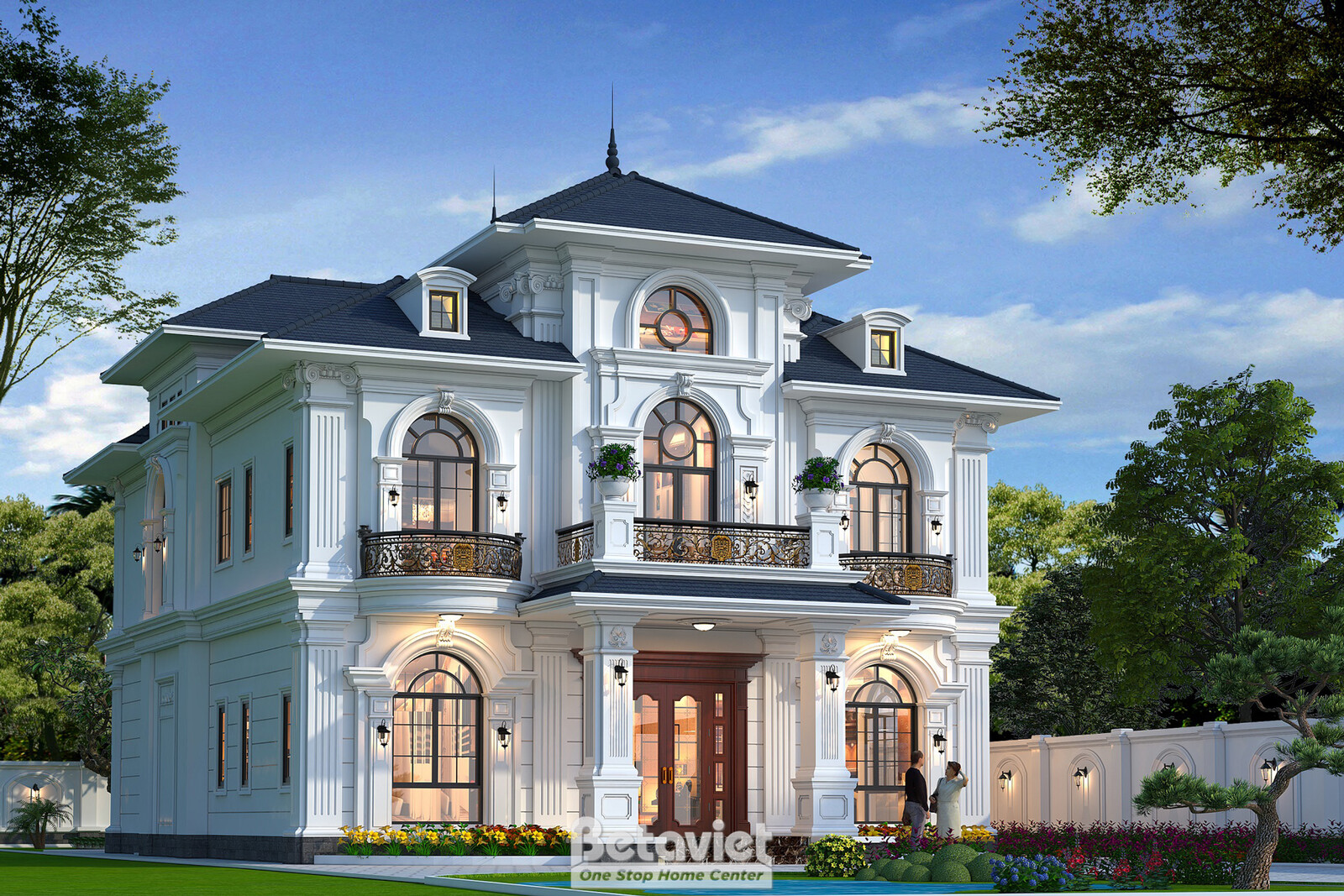 Góc mặt tiền bên phải lúc hoàng hôn, ánh đèn vàng ấm từ các cửa sổ cung tròn hắt ra, tường trắng đắp phào chỉ nổi khối, hà…