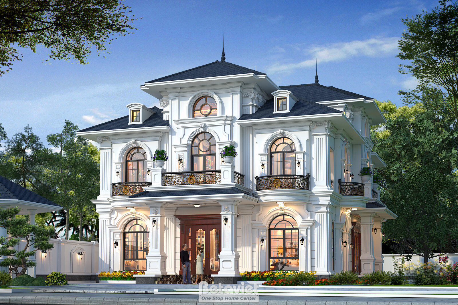 Góc trái mặt tiền ban ngày, gazebo mái chóp nhỏ đặt ở góc vườn, ban công sắt uốn nghệ thuật tầng hai, cửa sổ vòm cung có p…