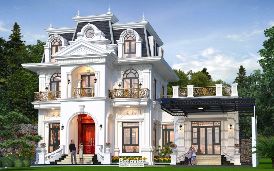 Góc nhìn hông biệt thự lộ khu hiên mái che khung sắt kính đen nối dài từ sảnh chính, bên dưới là sân vườn cỏ xanh có người…